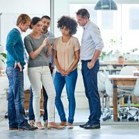 Shot of a group of office colleagues having a discussion over a digital tablet.